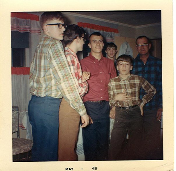 My wife's father and brothers posing at home. Her dad Richard is the rebellious one in the red non-plaid shirt. Their dad is on the far right